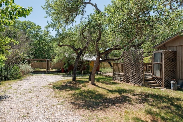 view of yard with fence and a wooden deck