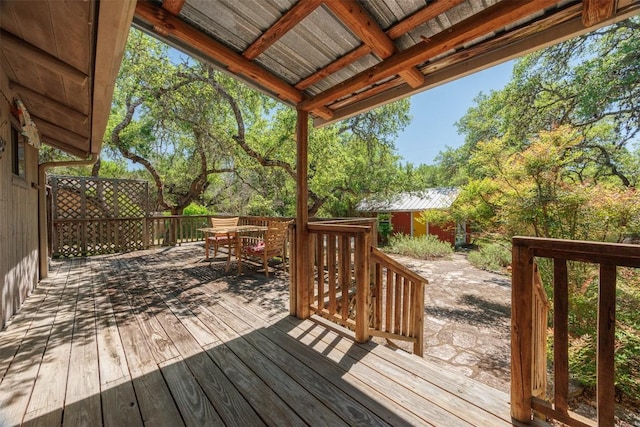deck featuring an outbuilding and outdoor dining area