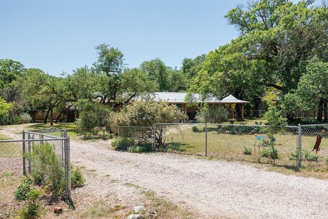 view of road with a gated entry and gravel driveway