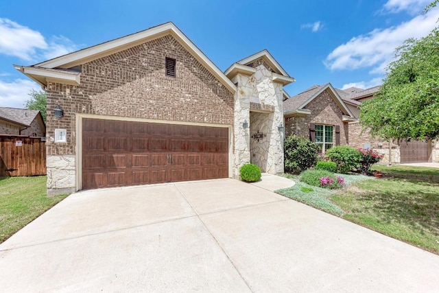4228 Hannover Way, Round Rock, TX 78681 - french country home featuring a garage, driveway, stone siding, and brick siding
