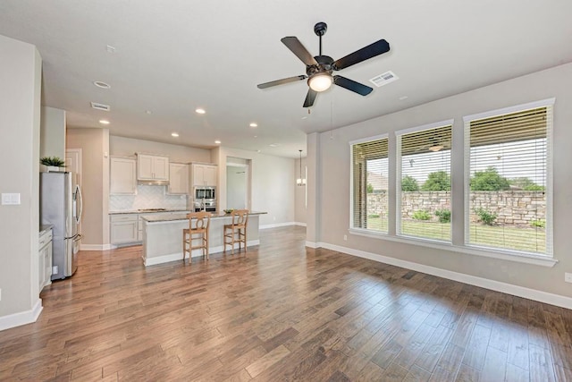 4228 Hannover Way, Round Rock, TX 78681 - unfurnished living room featuring baseboards, visible vents, light wood-style floors, and ceiling fan