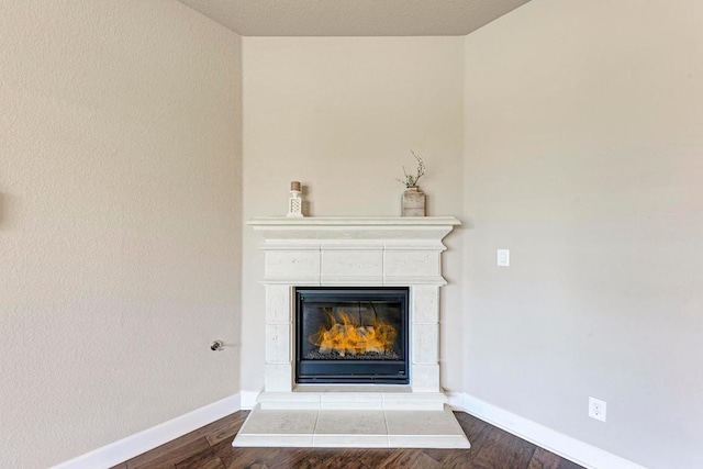 4228 Hannover Way, Round Rock, TX 78681 - interior details featuring baseboards, a glass covered fireplace, and wood finished floors