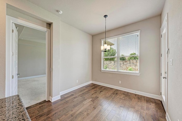 4228 Hannover Way, Round Rock, TX 78681 - unfurnished dining area with baseboards, dark wood-style flooring, and a chandelier