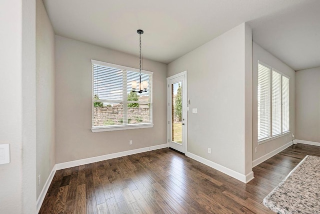 4228 Hannover Way, Round Rock, TX 78681 - unfurnished dining area featuring dark wood-type flooring, baseboards, and a chandelier