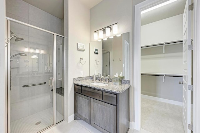 4228 Hannover Way, Round Rock, TX 78681 - bathroom with a shower stall, a spacious closet, and vanity