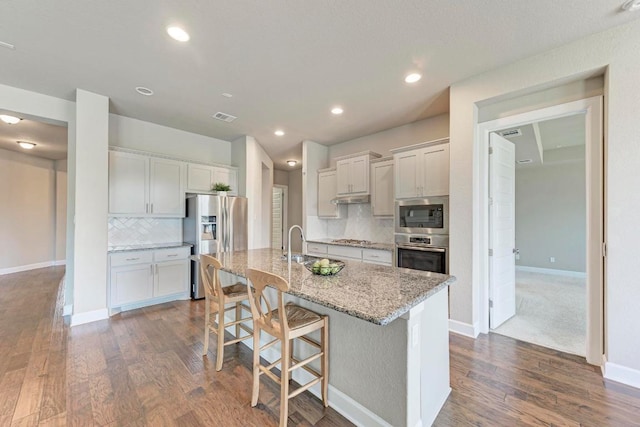 4228 Hannover Way, Round Rock, TX 78681 - kitchen featuring stainless steel appliances, visible vents, backsplash, and dark wood finished floors