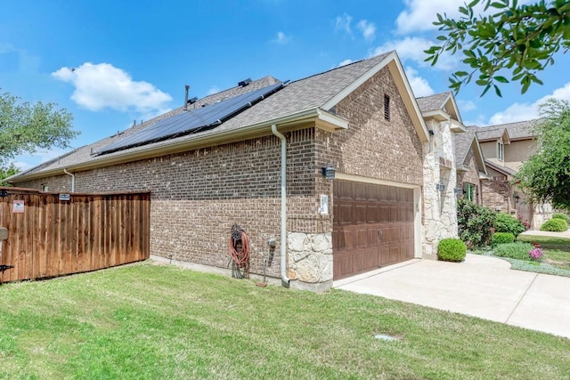 4228 Hannover Way, Round Rock, TX 78681 - view of property exterior with concrete driveway, brick siding, an attached garage, a yard, and roof mounted solar panels