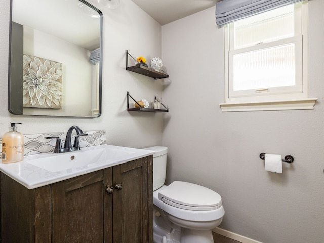 9200 Collingwood Dr, Austin, TX 78748 - half bath with vanity, toilet, decorative backsplash, and baseboards