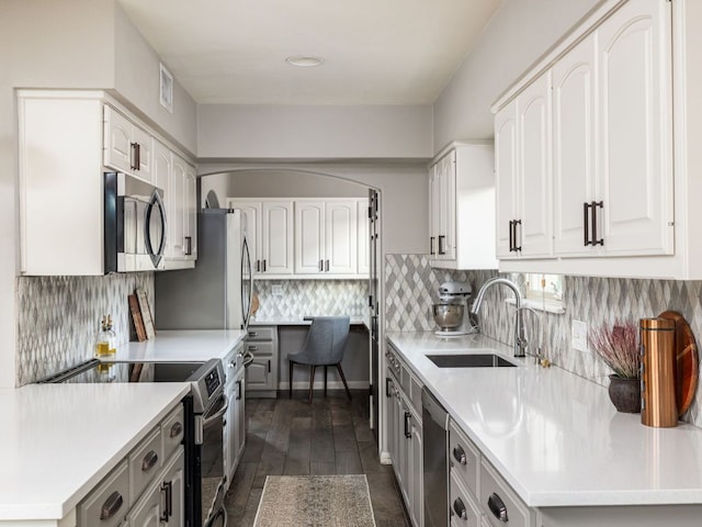 9200 Collingwood Dr, Austin, TX 78748 - kitchen featuring appliances with stainless steel finishes, a sink, light countertops, and white cabinets