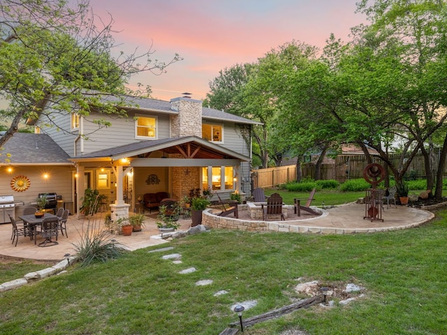 9200 Collingwood Dr, Austin, TX 78748 - back of property with an outdoor fire pit, a patio, and a chimney