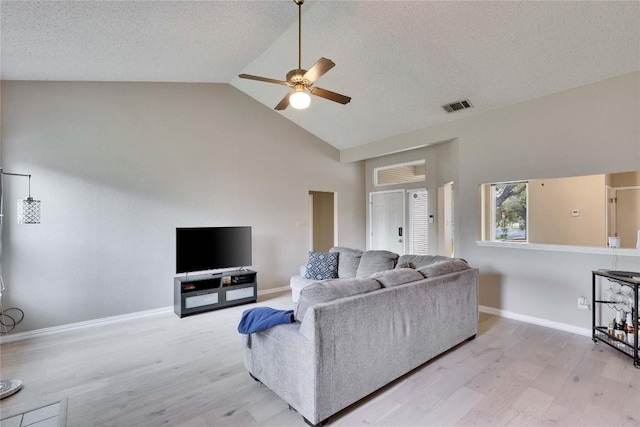3100 Jubilee Trl, Austin, TX 78748 - living room featuring a ceiling fan, light wood-style flooring, high vaulted ceiling, baseboards, and a textured ceiling