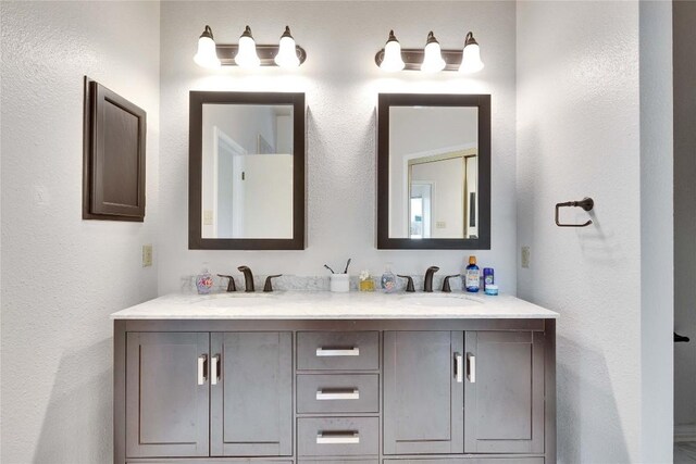 3100 Jubilee Trl, Austin, TX 78748 - bathroom featuring double vanity and a textured wall