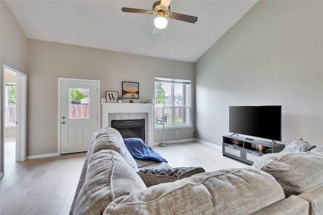 3100 Jubilee Trl, Austin, TX 78748 - living room featuring vaulted ceiling, wood finished floors, ceiling fan, a fireplace, and baseboards