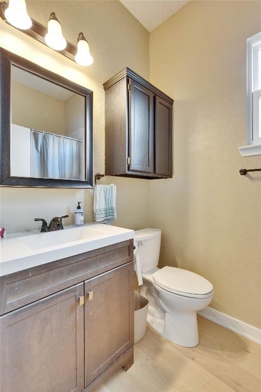 3100 Jubilee Trl, Austin, TX 78748 - full bath with vanity, toilet, wood finished floors, and baseboards