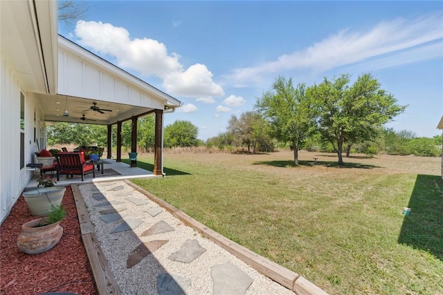 view of yard with a ceiling fan and a patio