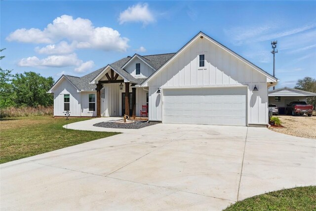 modern farmhouse style home featuring a front lawn, concrete driveway, board and batten siding, an attached garage, and roof with shingles