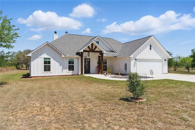 modern farmhouse with a chimney, an attached garage, concrete driveway, and board and batten siding