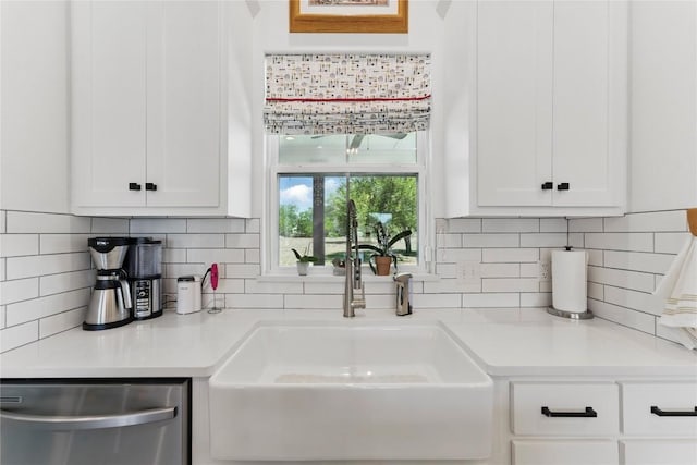 kitchen with dishwasher, white cabinetry, a sink, and light countertops