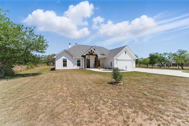modern farmhouse style home featuring board and batten siding, driveway, a front yard, and a garage