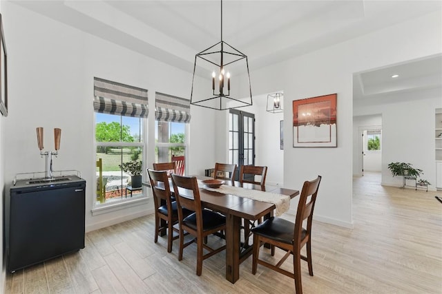dining room with light wood finished floors, baseboards, an inviting chandelier, and recessed lighting