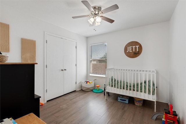 6801 Campina Xing, Del Valle, TX 78617 - unfurnished bedroom with wood finished floors, a crib, a ceiling fan, and a closet
