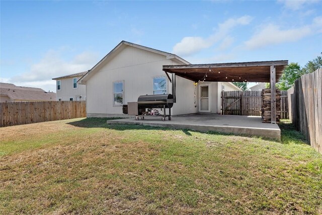 6801 Campina Xing, Del Valle, TX 78617 - back of property with a patio and a fenced backyard