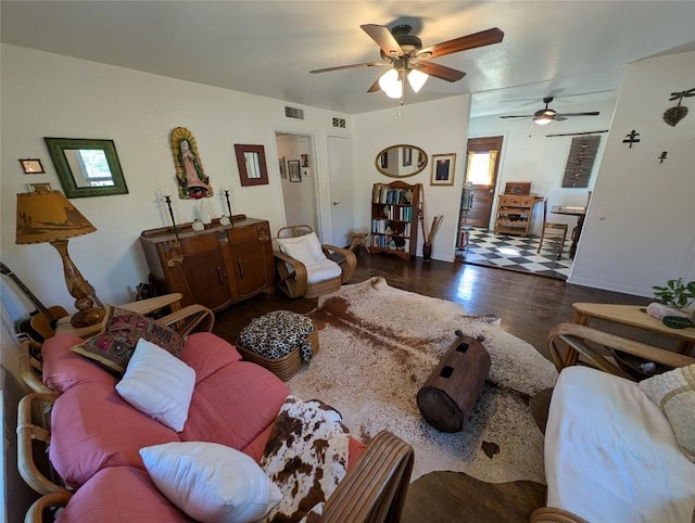 living room with ceiling fan, wood finished floors, and visible vents