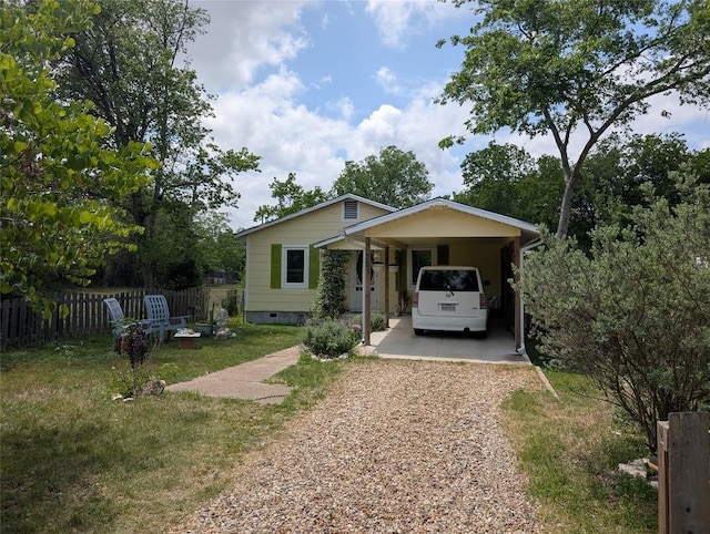 bungalow-style house featuring fence, dirt driveway, crawl space, a front yard, and a carport
