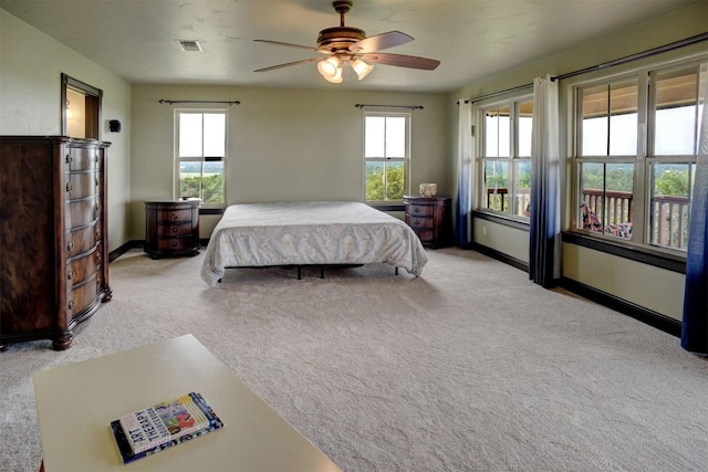 bedroom with visible vents, carpet flooring, and multiple windows