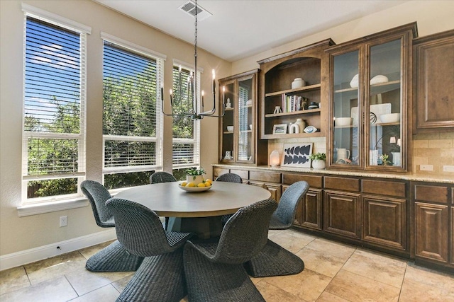8813 Fescue Ln, Austin, TX 78738 - dining space with healthy amount of natural light, light tile patterned floors, and baseboards