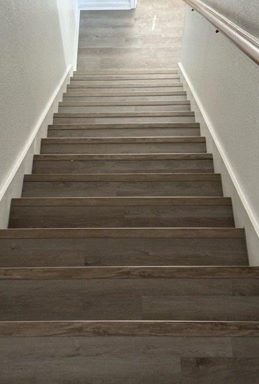 stairs featuring a textured wall
