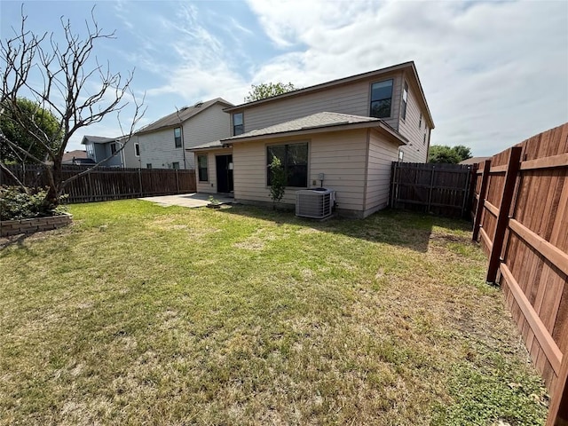 rear view of property featuring cooling unit, a yard, a patio area, and a fenced backyard