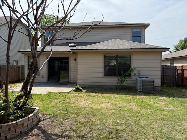 rear view of property featuring a yard, a patio, central AC unit, and fence