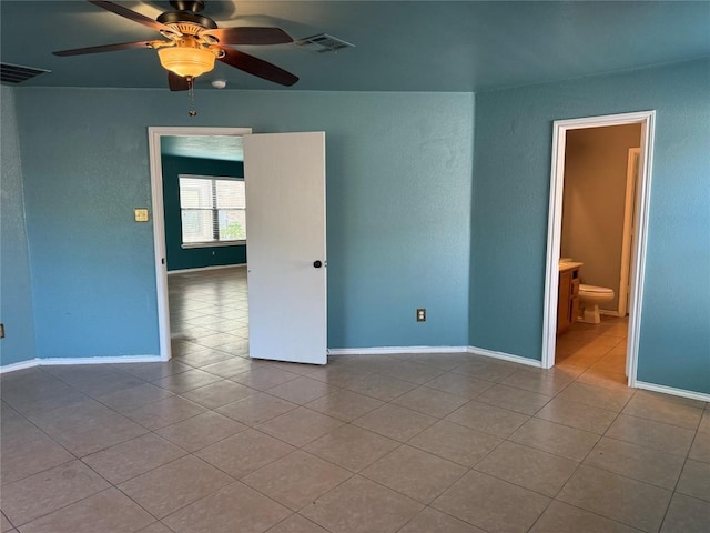 unfurnished room featuring tile patterned floors, a ceiling fan, and visible vents