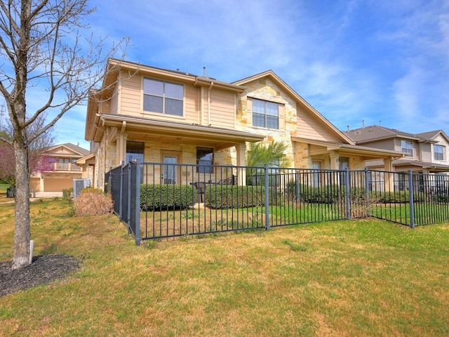 view of front of house featuring fence, stone siding, and a front yard