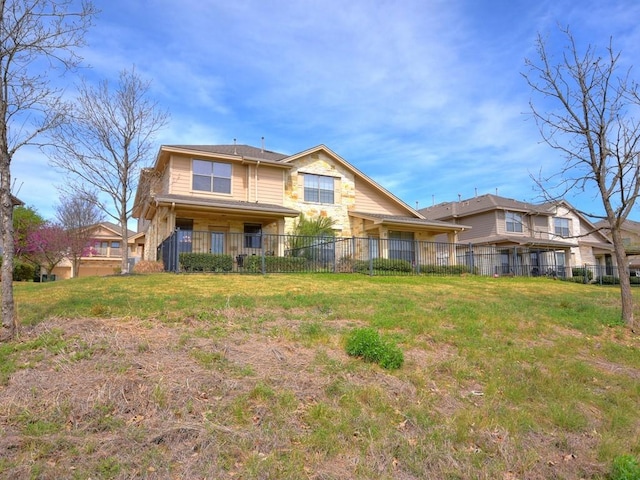 rear view of property featuring fence