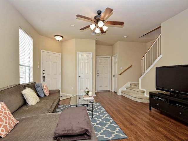 living room with ceiling fan, stairs, wood finished floors, and baseboards
