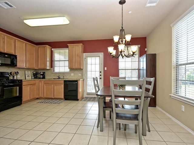 kitchen featuring tasteful backsplash, an inviting chandelier, visible vents, and black appliances