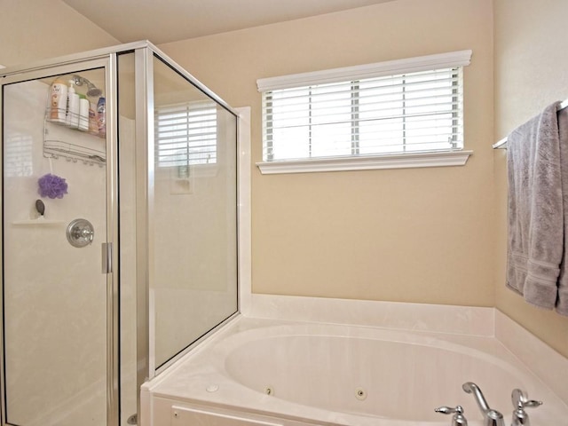 full bath featuring a jetted tub and a stall shower