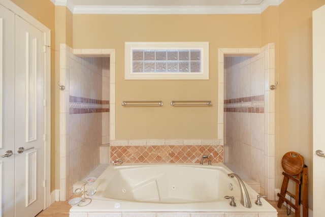 bathroom featuring ornamental molding and a tub with jets