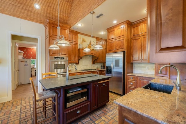 kitchen featuring stainless steel appliances, visible vents, a sink, and brick floor