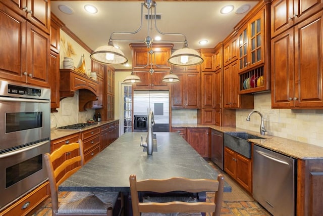 kitchen featuring a sink, decorative backsplash, glass insert cabinets, appliances with stainless steel finishes, and recessed lighting