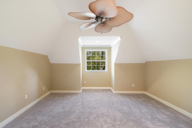 bonus room featuring vaulted ceiling, carpet floors, baseboards, and ceiling fan