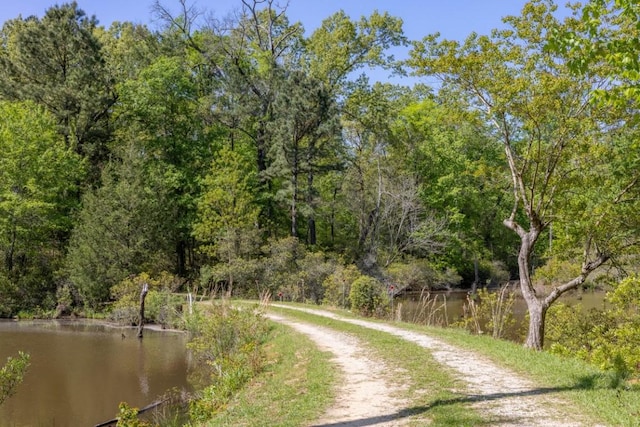 view of street featuring a water view and a wooded view