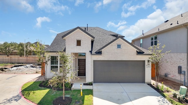 316 Ridgewell Loop, Georgetown, TX 78633 - french provincial home with brick siding, concrete driveway, roof with shingles, and an attached garage