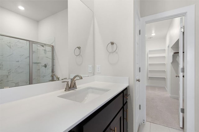 316 Ridgewell Loop, Georgetown, TX 78633 - full bathroom with vanity, a stall shower, recessed lighting, tile patterned flooring, and a spacious closet