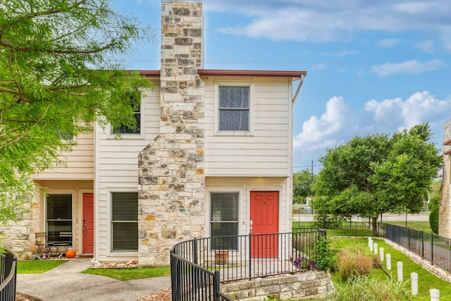 6900 E Riverside Dr Unit 24, Austin, TX 78741 - back of property featuring fence and a chimney
