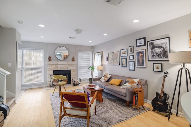 6900 E Riverside Dr Unit 24, Austin, TX 78741 - living area with light wood finished floors, baseboards, visible vents, and a healthy amount of sunlight