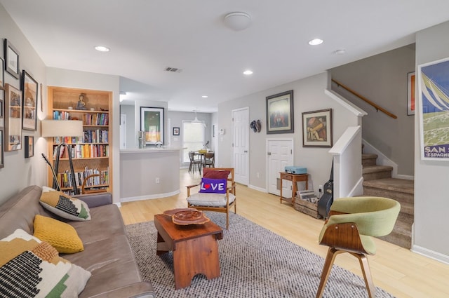 6900 E Riverside Dr Unit 24, Austin, TX 78741 - living area with light wood-type flooring, baseboards, visible vents, recessed lighting, and stairway