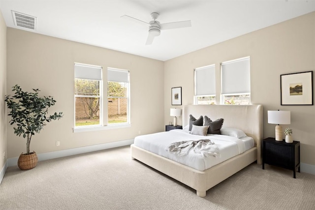 carpeted bedroom featuring baseboards, visible vents, and ceiling fan